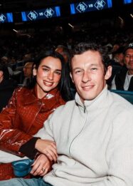 Gaya Dua Lipa Saat Menonton Yankees dengan Mantel Kulit Buaya Burgundy Koleksi Chanel Métiers d’Art